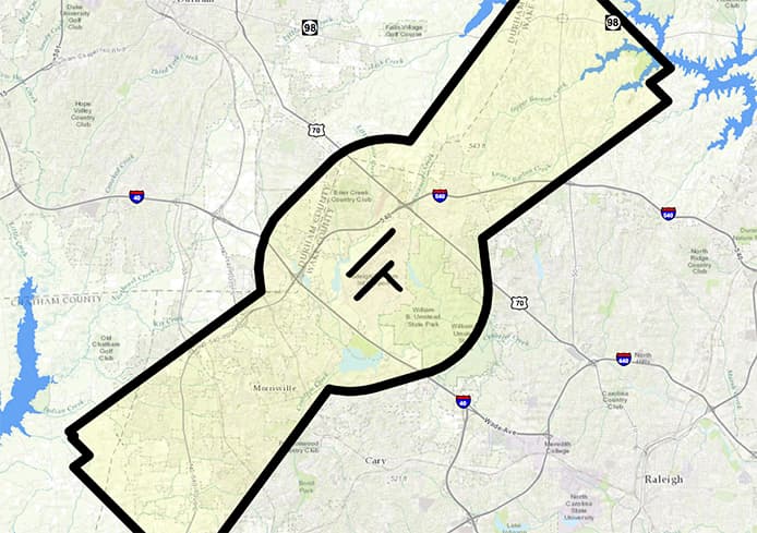 Map showing a highlighted district boundary in black outline over a region with roads, highways, and a blue lake in the corner.